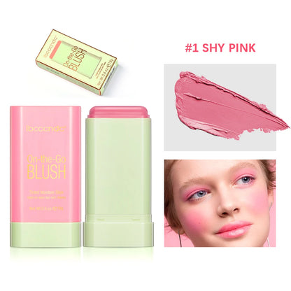 Stick de blush rose mat format bar ouvert, texture crème veloutée sur fond urbain chic.